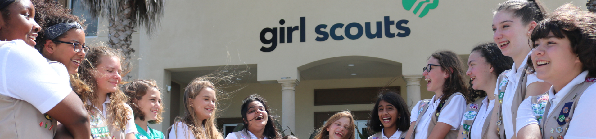  two high school girls hugging while staring at the camera with content facial expressions 