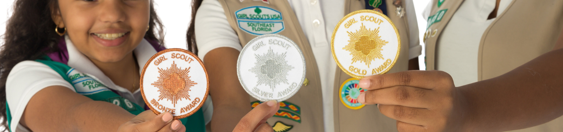  girl scout ambassador high school girl in school wearing sash with highest awards pins 